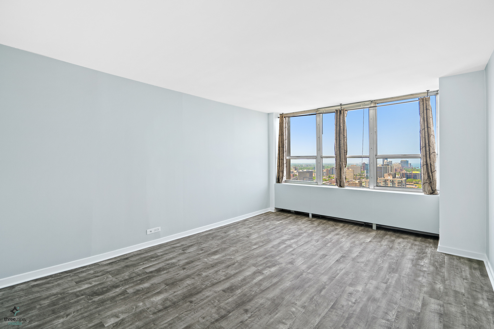 655 West Irving Park Road, Unit 3214 Chicago, IL 60613 - Photo 18 of 37 an empty room with wooden floor and windows