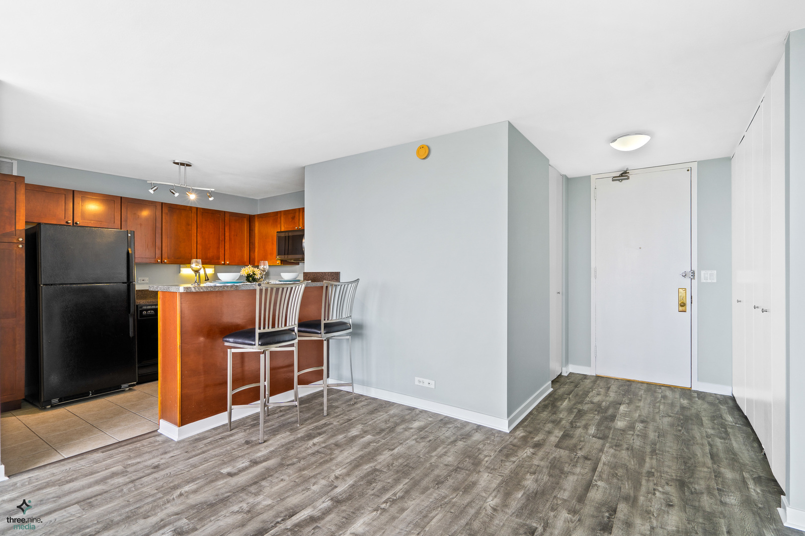 655 West Irving Park Road, Unit 3214 Chicago, IL 60613 - Photo 10 of 37 a kitchen with stainless steel appliances kitchen island granite countertop a refrigerator and a sink