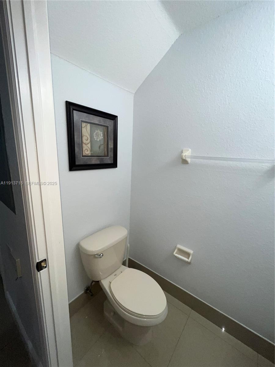 4929 Southwest 140th Terrace, Unit 5 Miramar, FL 33027 - Photo 11 of 42 a white toilet sitting next to a small sink