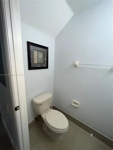 a bathroom with a sink mirror and toilet