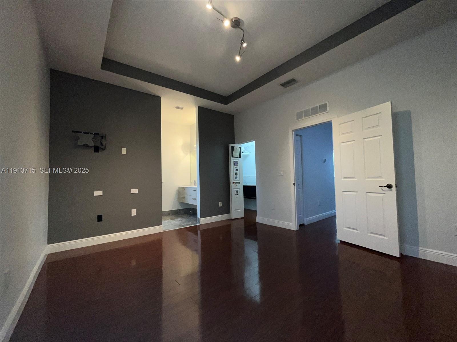 4929 Southwest 140th Terrace, Unit 5 Miramar, FL 33027 - Photo 21 of 42 an empty room with wooden floor and windows