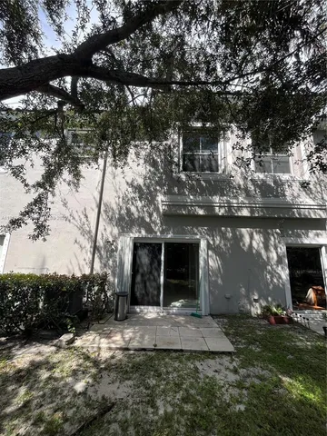 a front view of a house with a garden and a garage