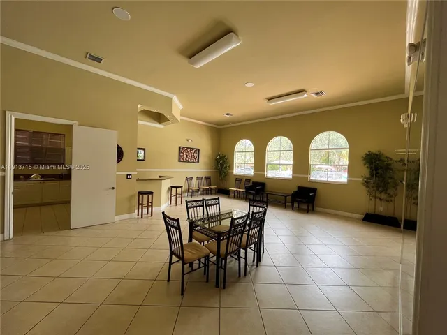 a large white kitchen with a stove a refrigerator and a sink