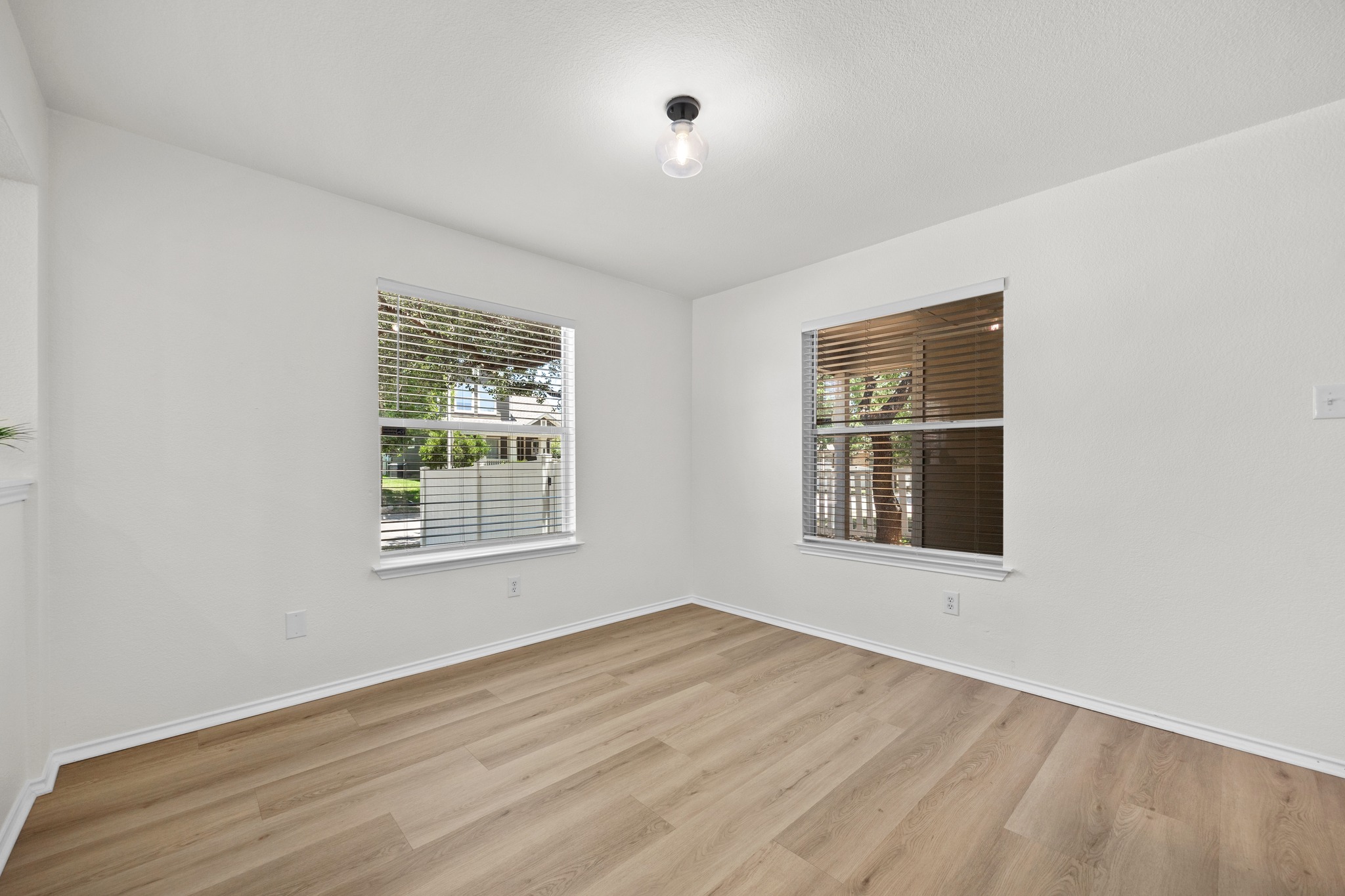 1818 Lost Maples Loop Cedar Park, TX 78613 - Photo 13 of 38 Hardwood-style flooring and abundant natural light create an inviting atmosphere in this versatile room.