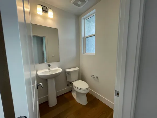 a bathroom with a sink toilet and a mirror