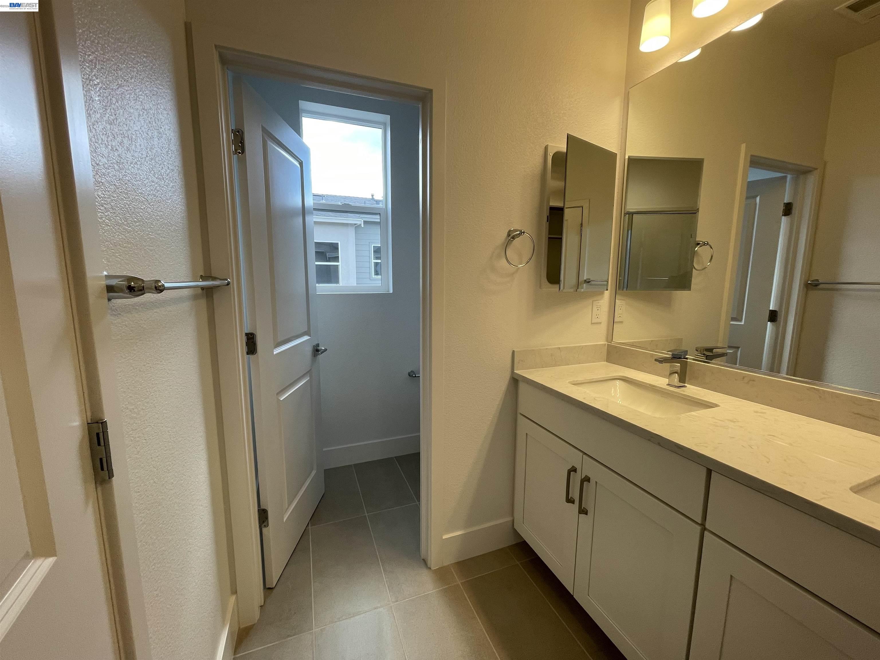 5708 Melon Court San Ramon, CA 94583 - Photo 15 of 31 a bathroom with a granite countertop sink mirror and a toilet