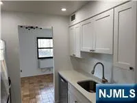 a kitchen with stainless steel appliances cabinets and a window