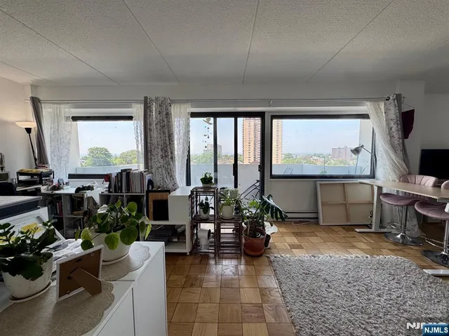 a living room with furniture large window and flat screen tv