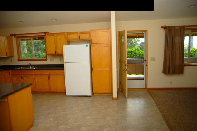 55 Ulumalu Road Haiku, HI 96708 - Photo 7 of 26 a kitchen with a refrigerator a stove top oven a sink and a large window