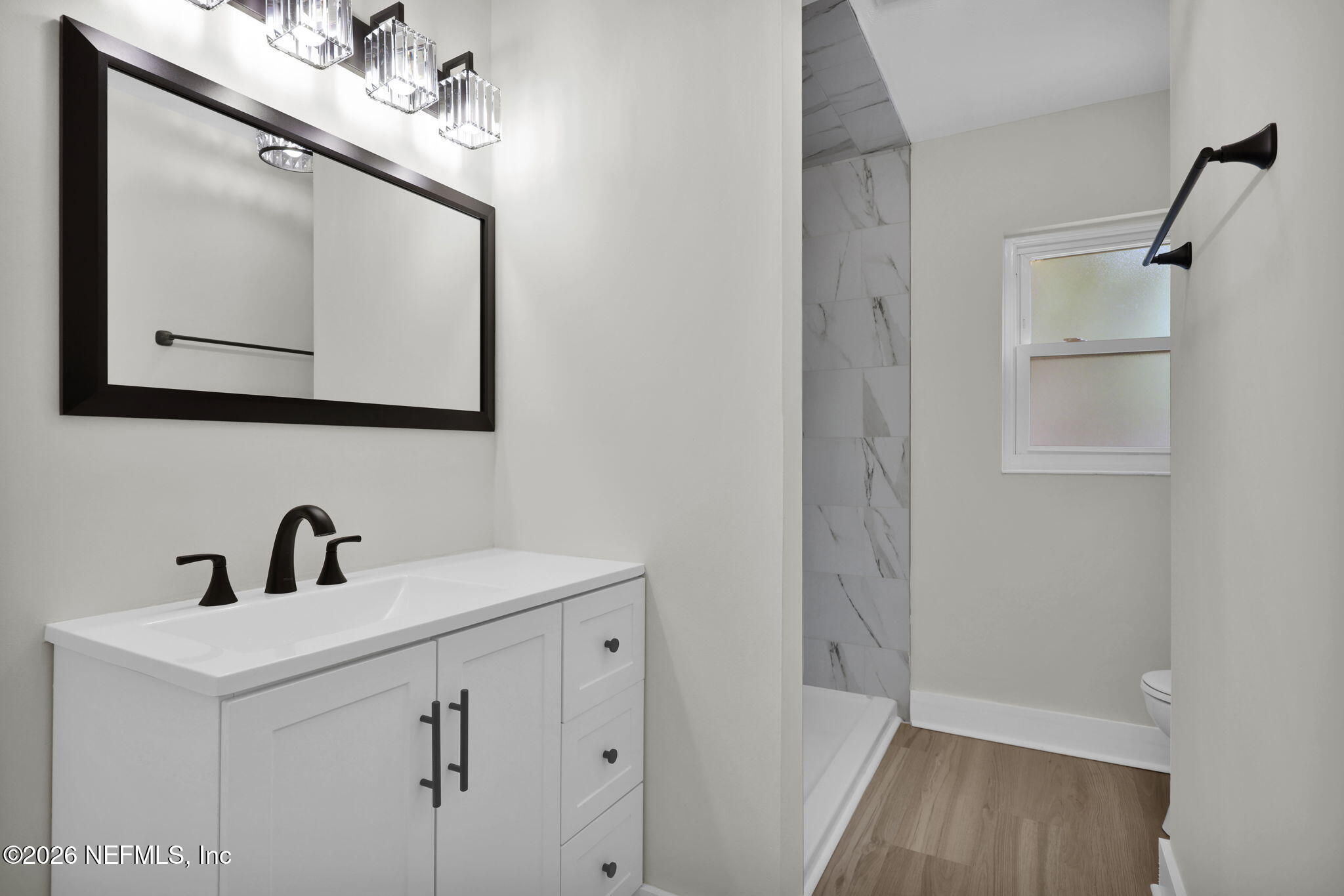 8544 Sanchez Road Jacksonville, FL 32217 - Photo 31 of 46 a bathroom with a sink mirror and vanity