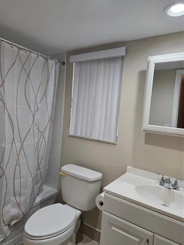 a bathroom with a sink toilet and vanity