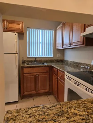 a kitchen with stainless steel appliances granite countertop a refrigerator sink and cabinets