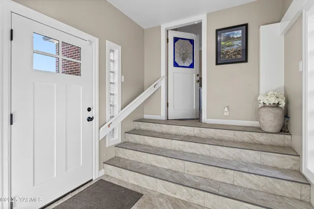 a bathroom with a potted plant on the counter and a sink