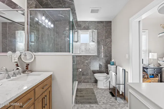 a bedroom with a bed flat screen tv and a large window