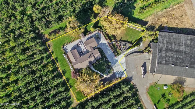 an aerial view of a house with a yard and potted plants
