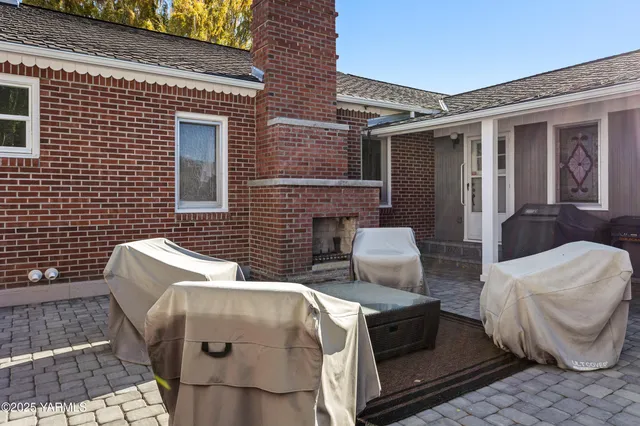a view of a roof deck with couches and potted plants