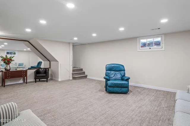 a living room with furniture and a potted plant