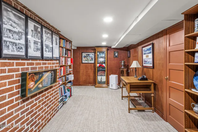 a room with furniture lots of books and a book shelf
