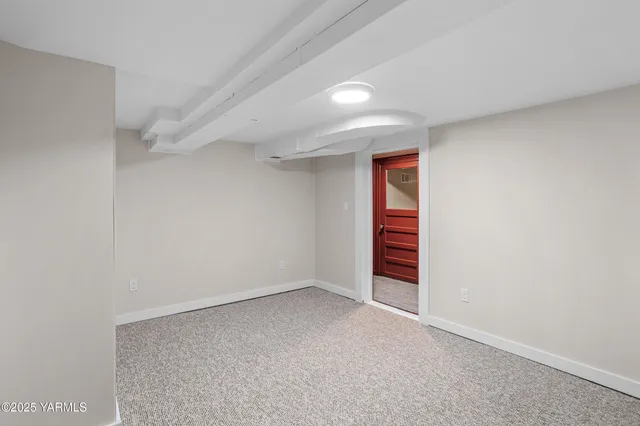 a view of an empty room and closet area