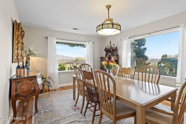 a view of a dining room with furniture window and wooden floor
