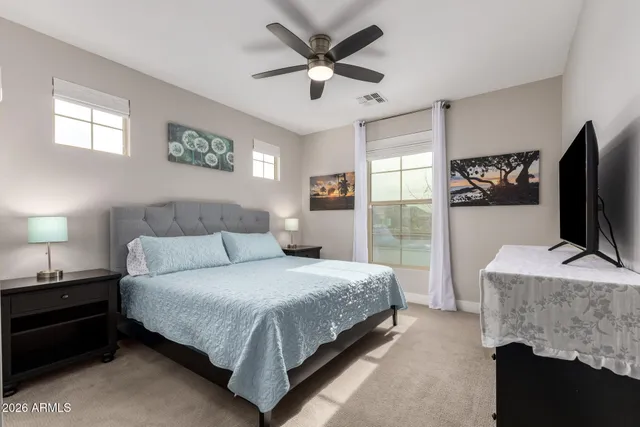 a bedroom with a bed and a flat screen tv