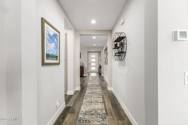 a view of a hallway with wooden floor and closet