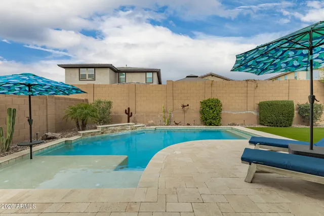 a view of swimming pool with seating area and furniture