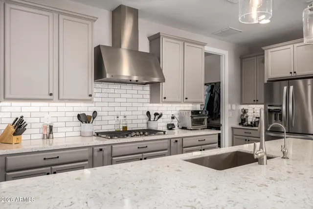 a kitchen with granite countertop a sink stainless steel appliances and cabinets