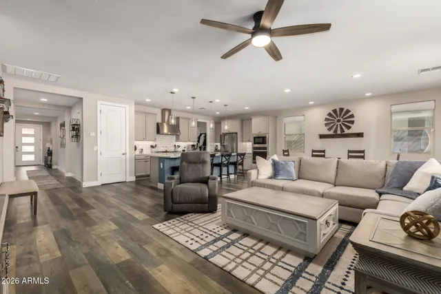 a living room with furniture and kitchen view