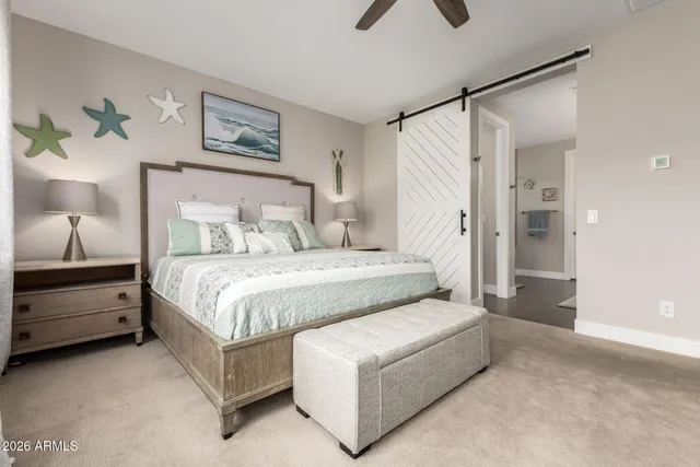 a bed room with a bed and a painting on the wall