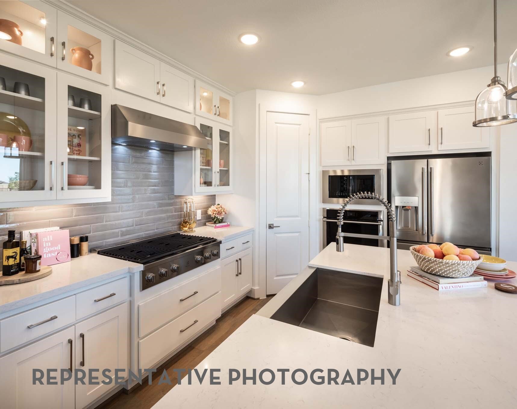 26535 Jolly Prairie Drive Hockley, TX 77447 - Photo 4 of 8 a kitchen with stainless steel appliances granite countertop a refrigerator and a stove top oven