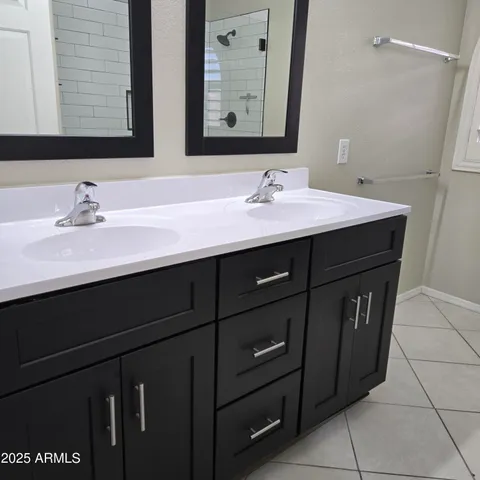 a bathroom with a sink vanity and mirror