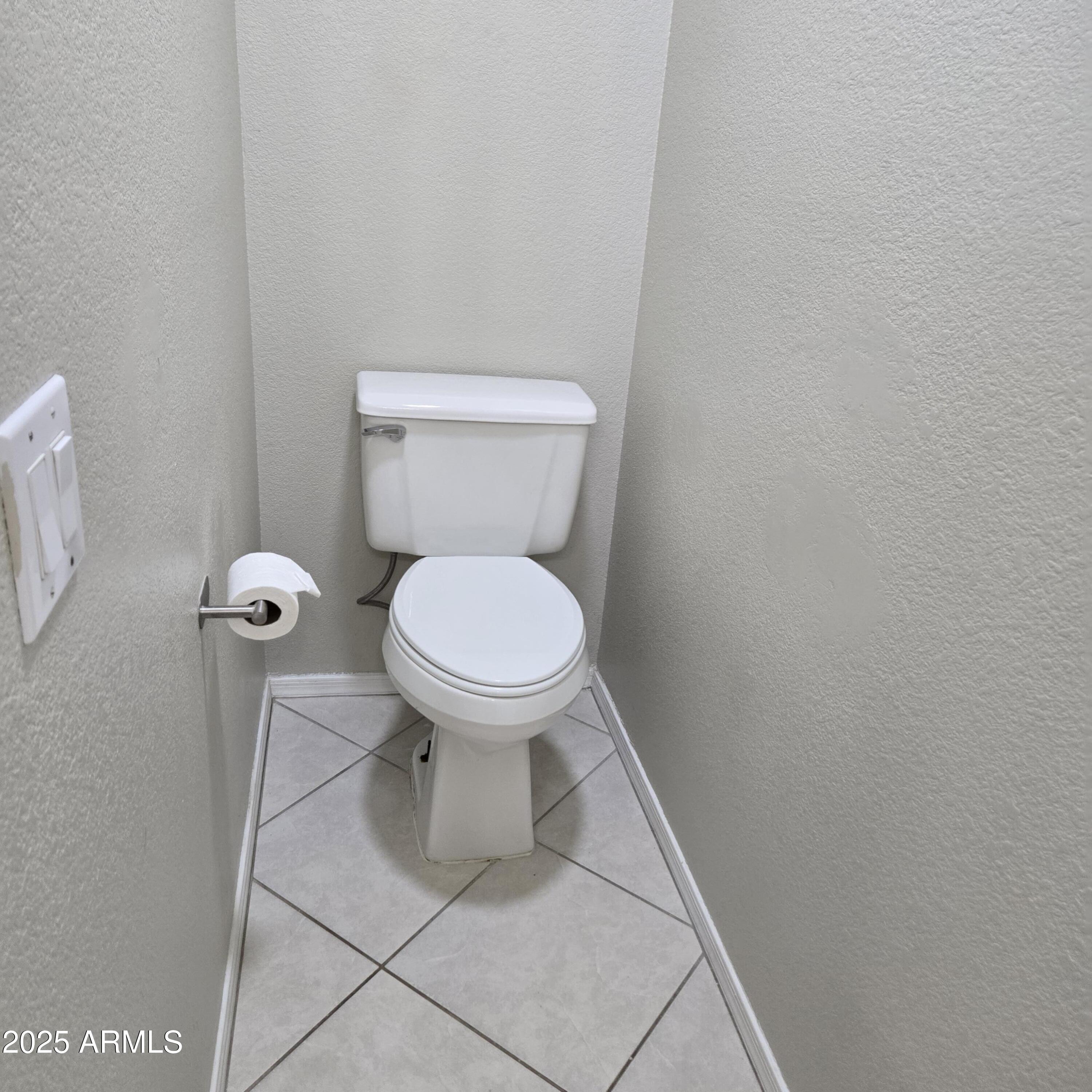 11525 West Cottontail Court Surprise, AZ 85378 - Photo 14 of 21 a white toilet sitting next to a white wall