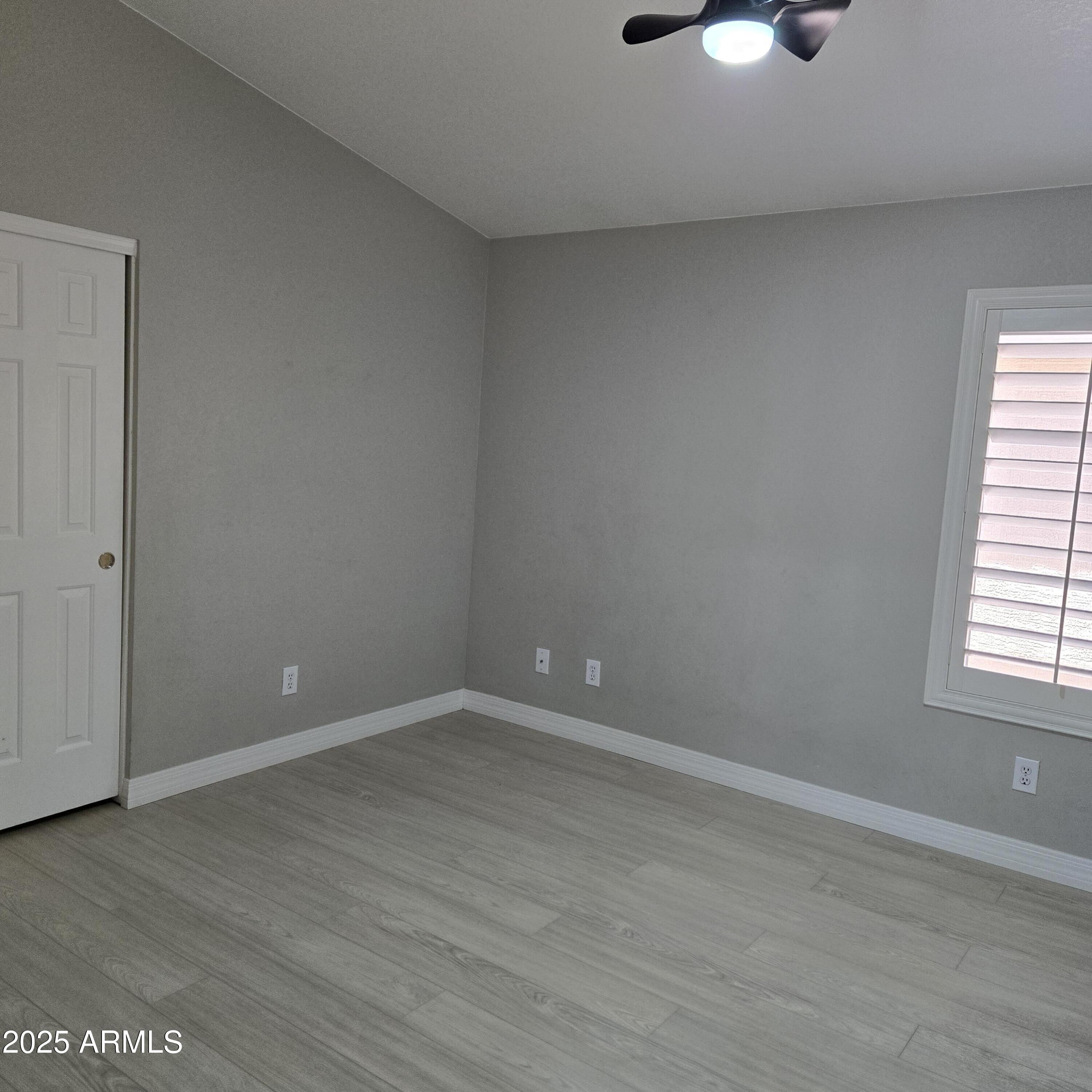11525 West Cottontail Court Surprise, AZ 85378 - Photo 15 of 21 an empty room with wooden floor and windows