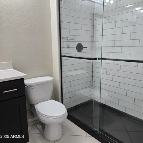 a bathroom with a toilet and a shower