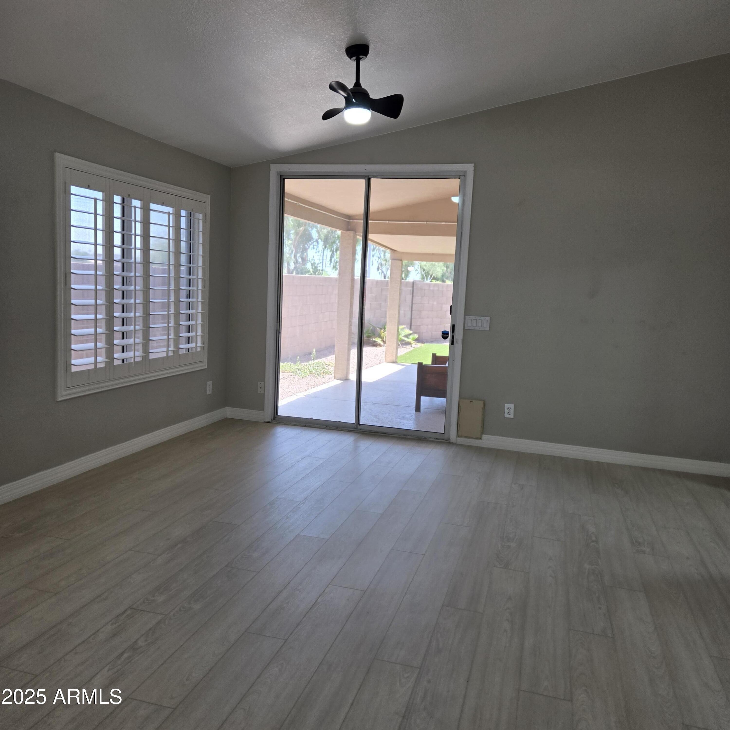 11525 West Cottontail Court Surprise, AZ 85378 - Photo 4 of 21 an empty room with wooden floor and windows