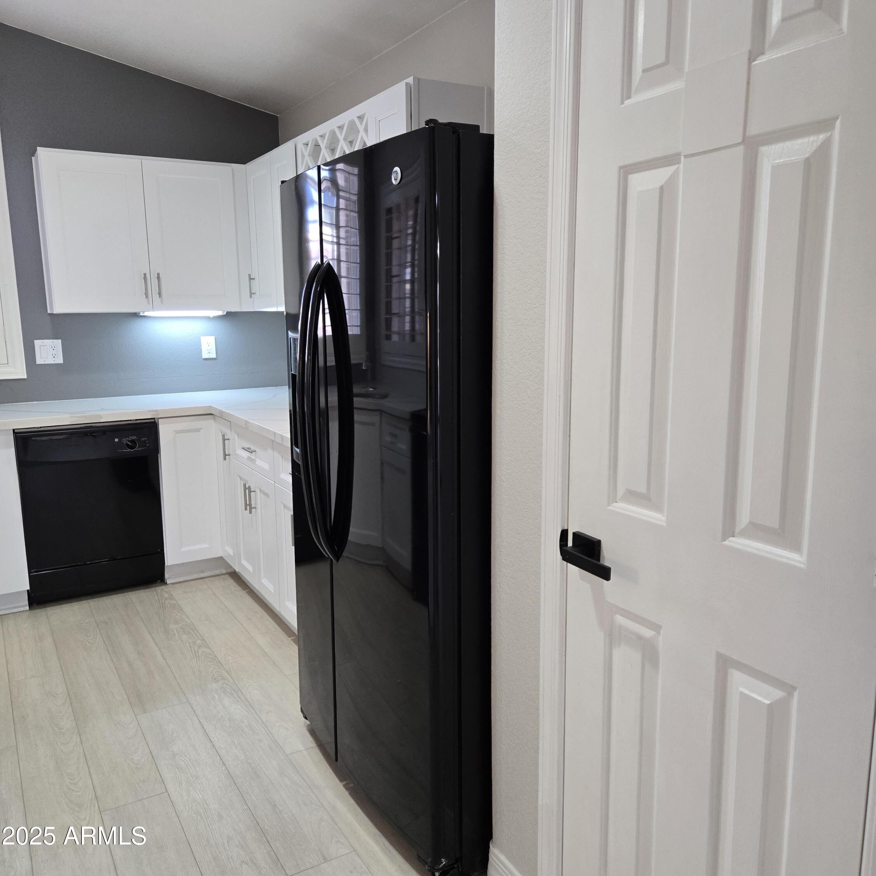 11525 West Cottontail Court Surprise, AZ 85378 - Photo 6 of 21 a kitchen with a refrigerator and cabinets