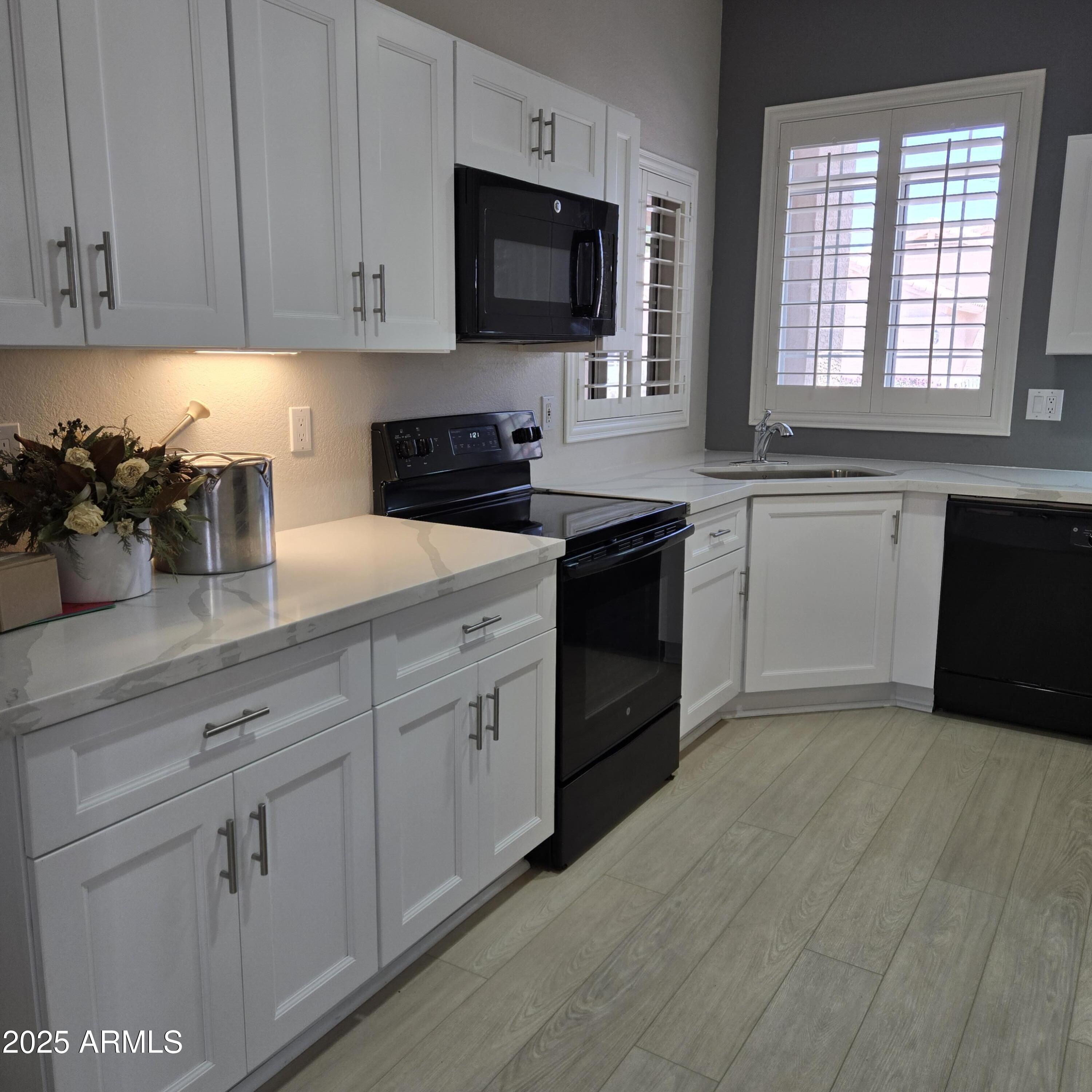 11525 West Cottontail Court Surprise, AZ 85378 - Photo 8 of 21 a kitchen with a sink stove and cabinets