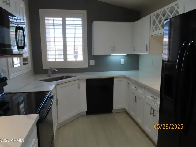 a kitchen with a sink dishwasher a stove and a refrigerator