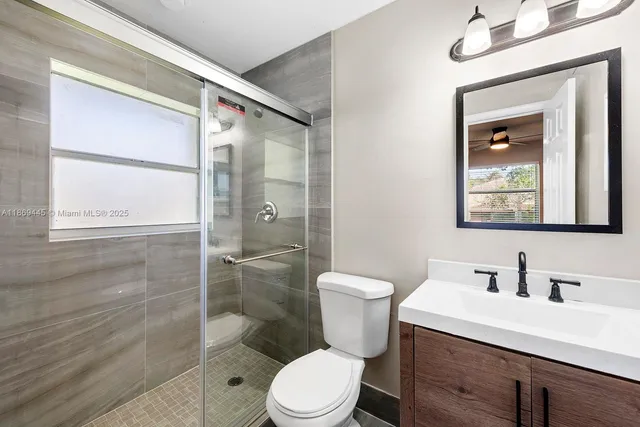 a bathroom with a toilet a sink and shower