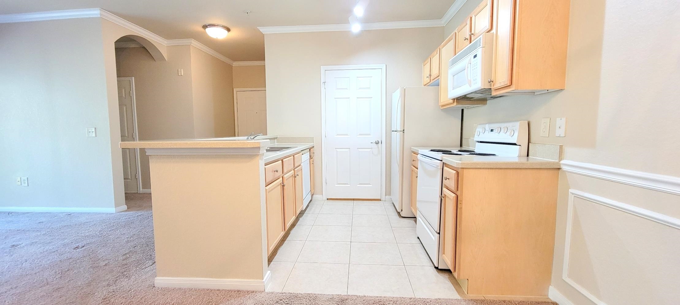 285 Old Village Center Circle, Unit 5206 St. Augustine, FL 32084 - Photo 11 of 17 a kitchen with stainless steel appliances a refrigerator and a stove