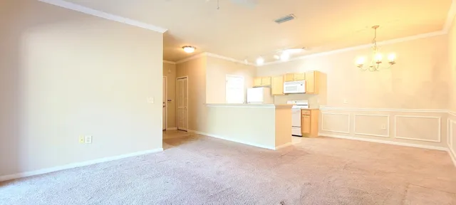 an empty room with windows and city view