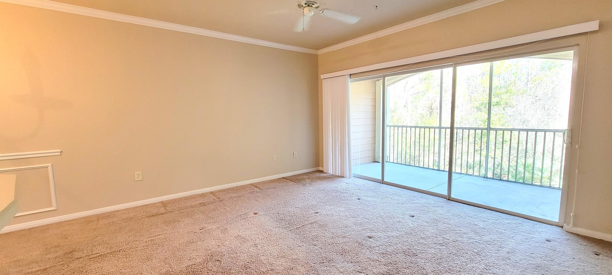 285 Old Village Center Circle, Unit 5206 St. Augustine, FL 32084 - Photo 15 of 17 an empty room with windows and city view