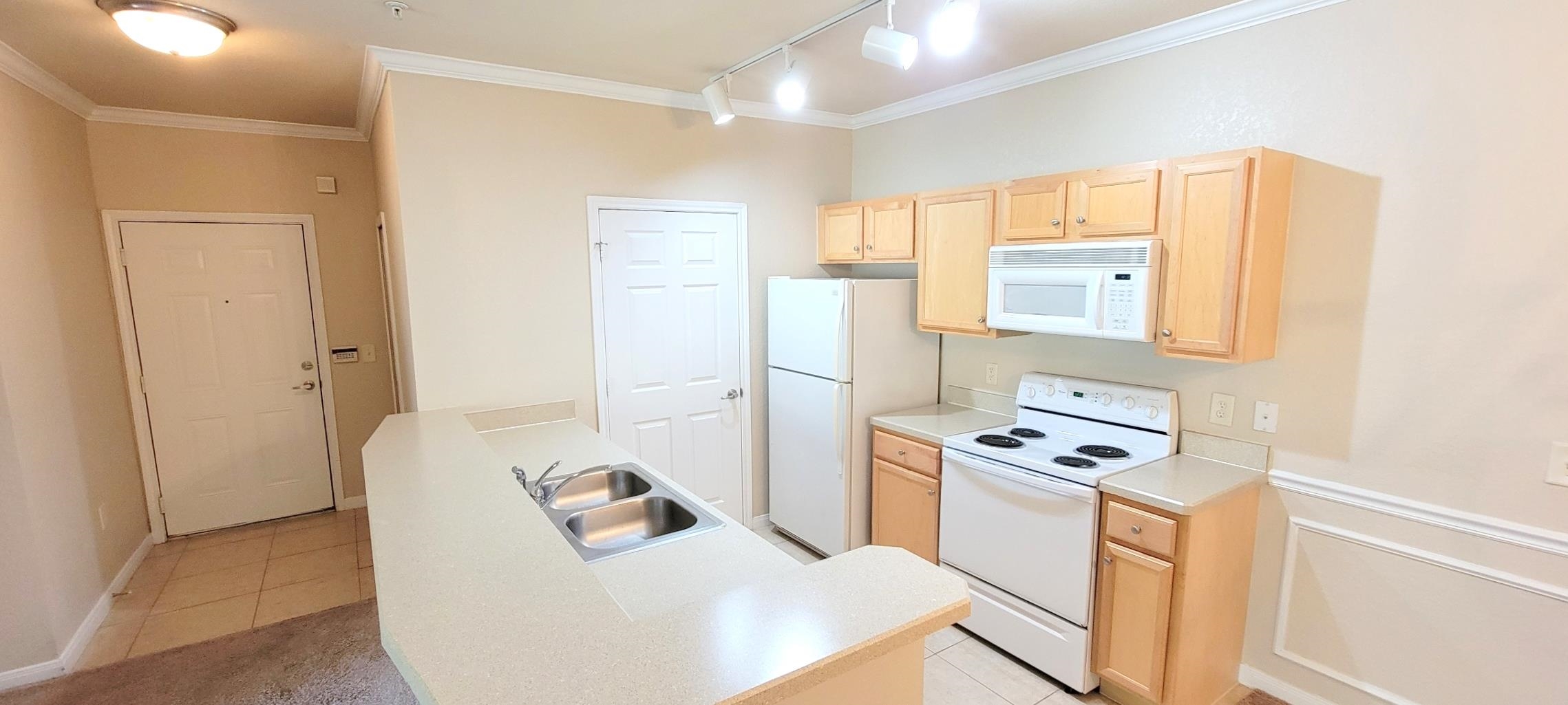 285 Old Village Center Circle, Unit 5206 St. Augustine, FL 32084 - Photo 9 of 17 a kitchen with stainless steel appliances a refrigerator a stove a microwave a sink and cabinets