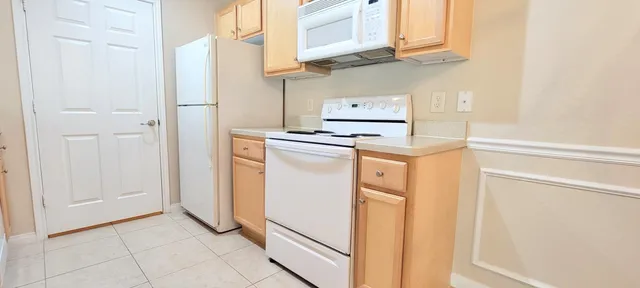 a kitchen with stainless steel appliances a refrigerator and a stove