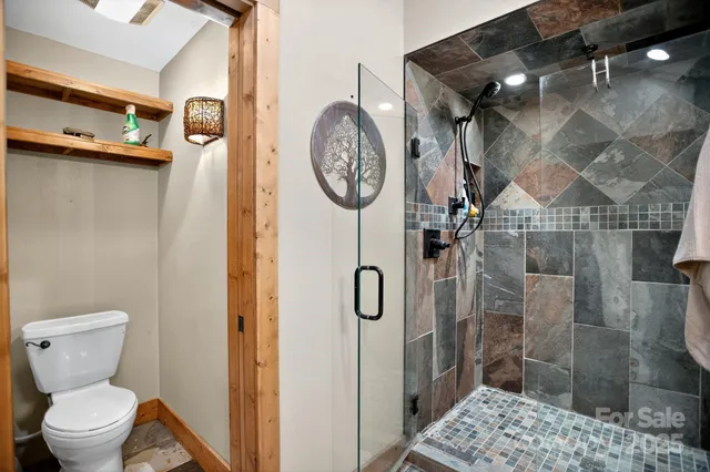 a bathroom with a toilet and a shower