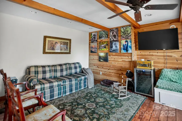 a bedroom with furniture and a flat screen tv