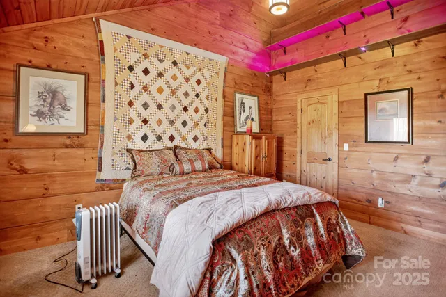 a bed sitting in a bedroom next to a small bathroom