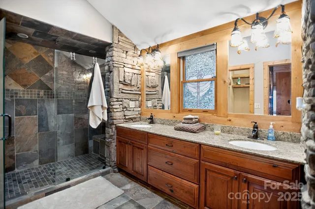 a bathroom with a granite countertop sink mirror and double