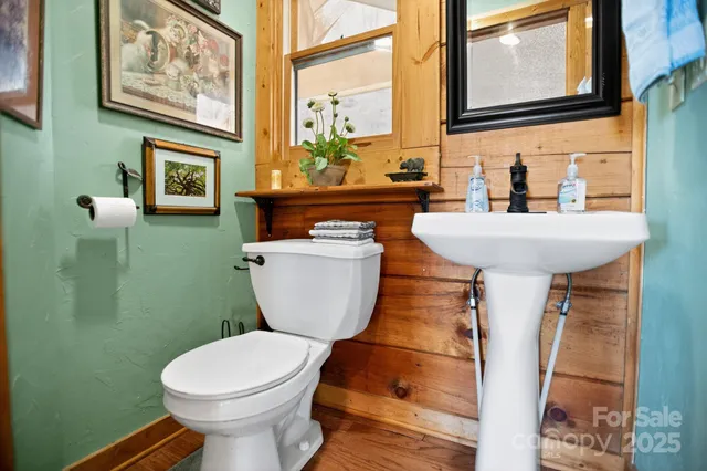a bathroom with a toilet a sink and a window